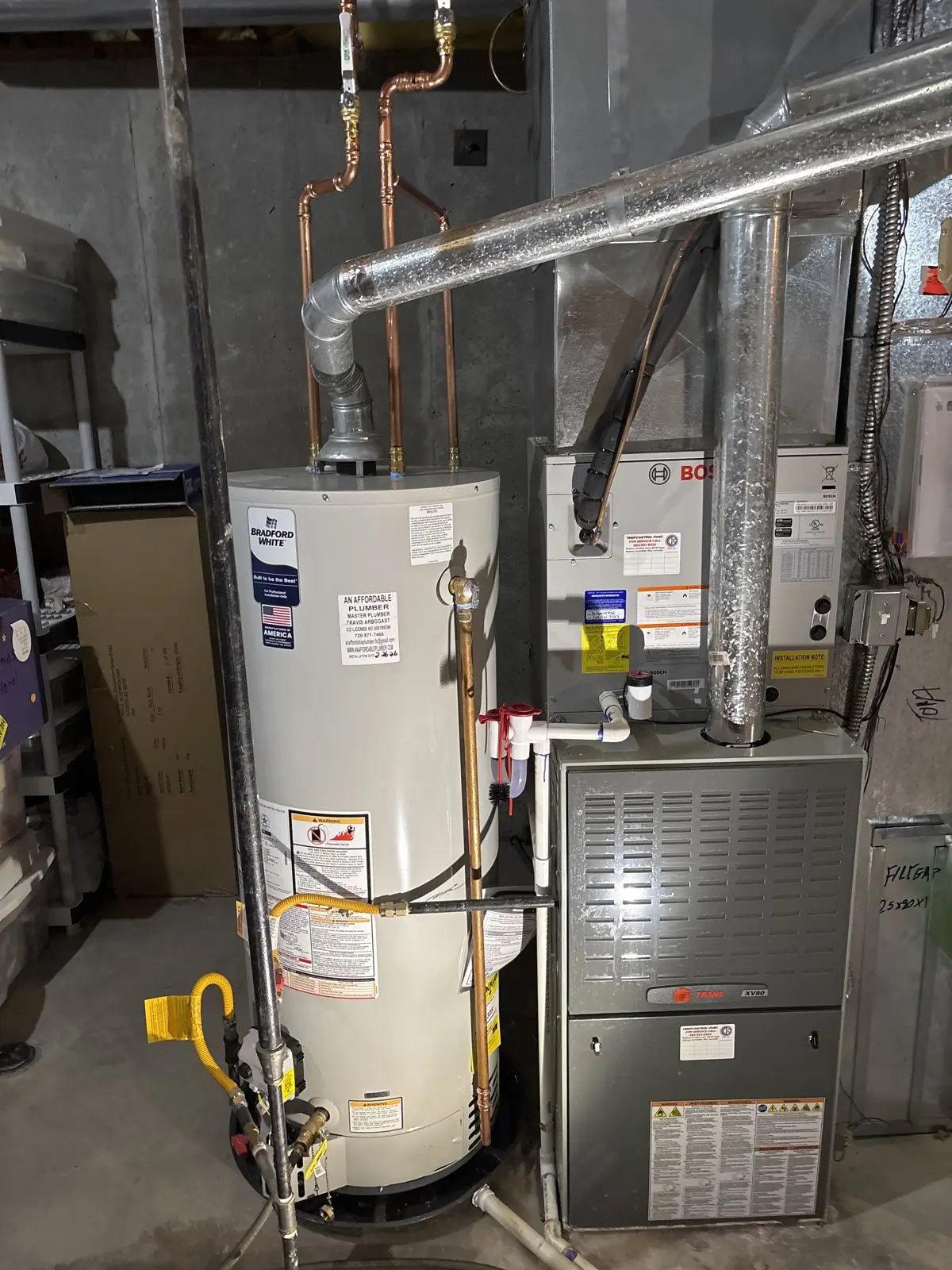 Water heater installation next to a furnace in a finished basement